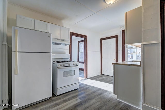 kitchen featuring white appliances, white cabinets, and hardwood / wood-style flooring