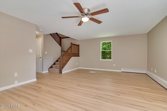 1039 Towpath Rd, Hawley, PA 18428 - unfurnished living room with stairs, ceiling fan, light wood-style floors, and a baseboard heating unit