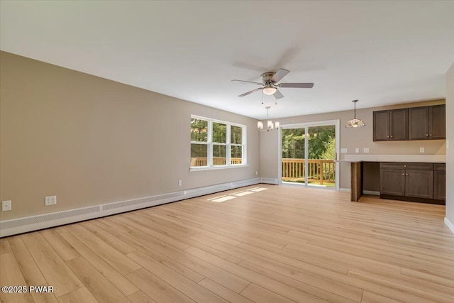 1039 Towpath Rd, Hawley, PA 18428 - unfurnished living room featuring a ceiling fan, light wood finished floors, a chandelier, and a baseboard heating unit