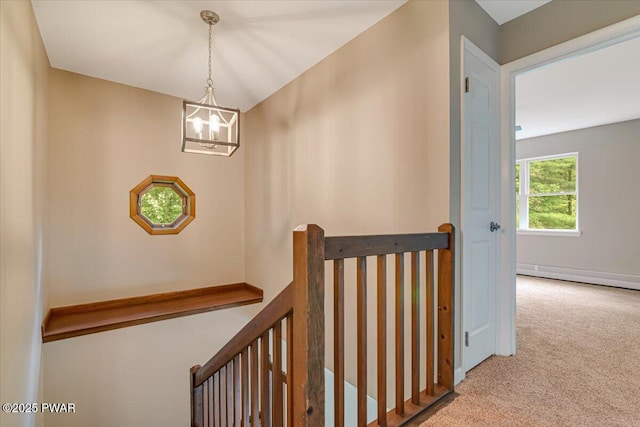 1039 Towpath Rd, Hawley, PA 18428 - corridor with an upstairs landing, carpet flooring, a chandelier, and a baseboard heating unit
