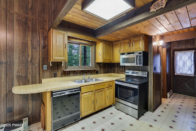 1086 Hampstead Rd, Bushkill, PA 18324 - kitchen with appliances with stainless steel finishes, a sink, wooden ceiling, wood walls, and light countertops