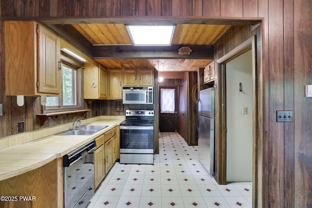 1086 Hampstead Rd, Bushkill, PA 18324 - kitchen with appliances with stainless steel finishes, light flooring, wood walls, wood ceiling with exposed beams, and a sink