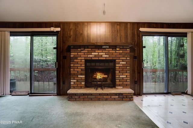 1086 Hampstead Rd, Bushkill, PA 18324 - unfurnished living room with wood walls, light colored carpet, and a fireplace