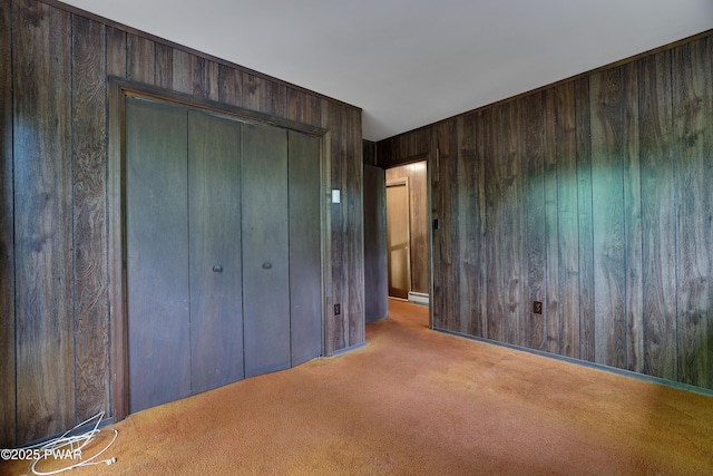 1086 Hampstead Rd, Bushkill, PA 18324 - unfurnished bedroom with wood walls, carpet, a baseboard radiator, and a closet