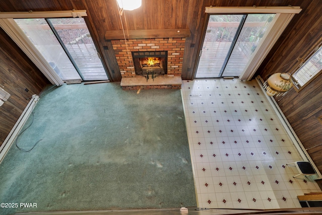 1086 Hampstead Rd, Bushkill, PA 18324 - unfurnished living room with wood walls and a brick fireplace