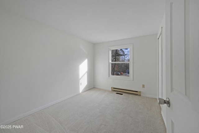 unfurnished bedroom with a baseboard heating unit, light colored carpet, and a closet