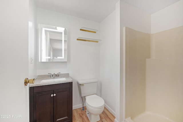 bathroom with vanity, hardwood / wood-style floors, toilet, and walk in shower