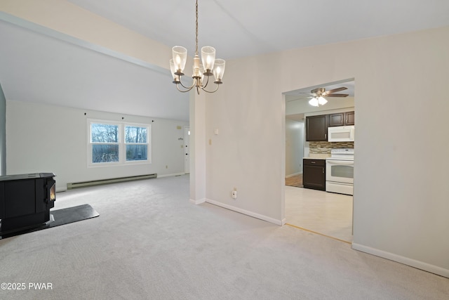 unfurnished living room featuring ceiling fan with notable chandelier, a baseboard radiator, light colored carpet, and a wood stove