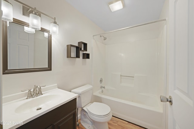 full bathroom with hardwood / wood-style flooring, shower / tub combination, vanity, and toilet