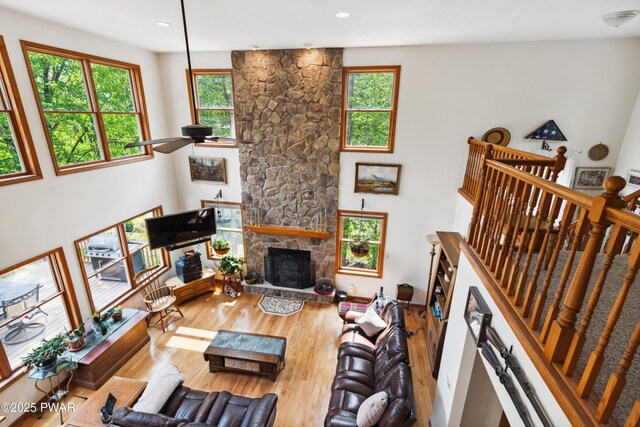 119 Canoebrook Dr, Hawley, PA 18428 - living area featuring plenty of natural light, a fireplace, wood finished floors, ceiling fan, and recessed lighting