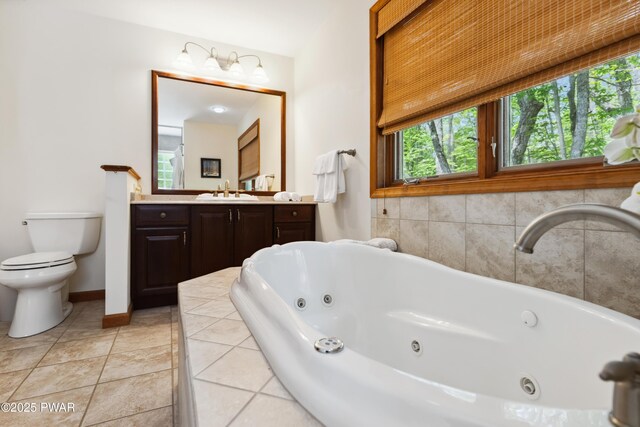119 Canoebrook Dr, Hawley, PA 18428 - bathroom with toilet, healthy amount of natural light, a tub with jets, and vanity