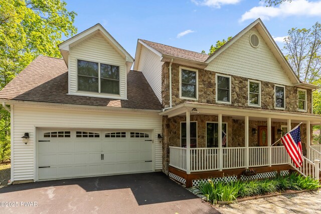 119 Canoebrook Dr, Hawley, PA 18428 - view of front of home featuring covered porch, stone siding, driveway, a garage, and roof with shingles