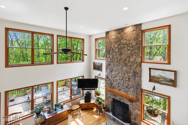 119 Canoebrook Dr, Hawley, PA 18428 - living room with wood finished floors, a stone fireplace, healthy amount of natural light, and recessed lighting