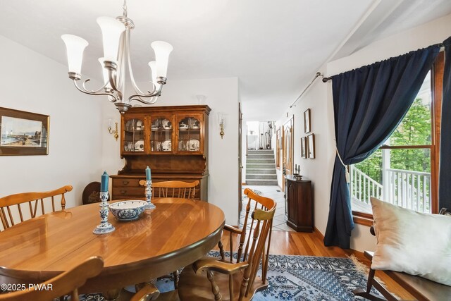 119 Canoebrook Dr, Hawley, PA 18428 - dining room featuring light wood-style flooring, a chandelier, and stairway