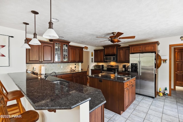 119 Canoebrook Dr, Hawley, PA 18428 - kitchen featuring appliances with stainless steel finishes, a sink, a ceiling fan, and backsplash