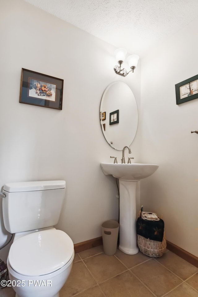 119 Canoebrook Dr, Hawley, PA 18428 - bathroom featuring toilet, tile patterned flooring, baseboards, and a textured ceiling