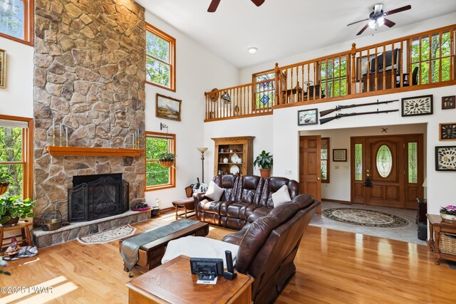119 Canoebrook Dr, Hawley, PA 18428 - living area with a ceiling fan, wood finished floors, high vaulted ceiling, healthy amount of natural light, and a stone fireplace