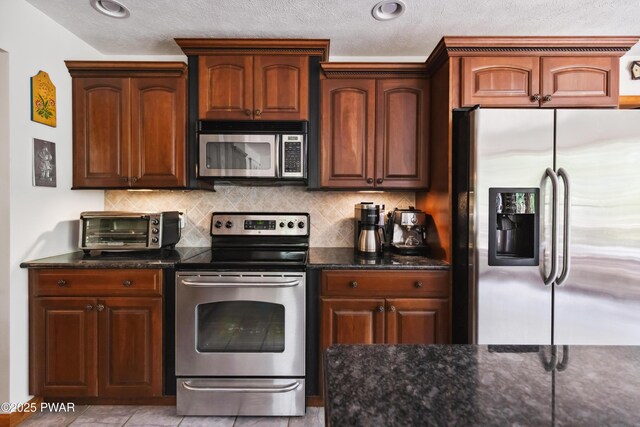 119 Canoebrook Dr, Hawley, PA 18428 - kitchen featuring stainless steel appliances, dark stone countertops, tasteful backsplash, and a textured ceiling