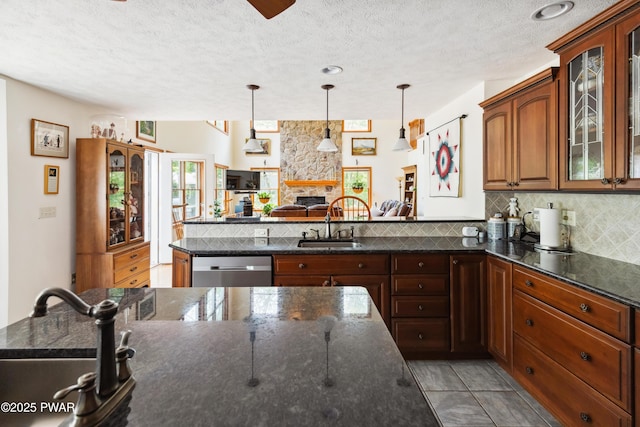 119 Canoebrook Dr, Hawley, PA 18428 - kitchen featuring a peninsula, stainless steel dishwasher, a sink, a textured ceiling, and backsplash