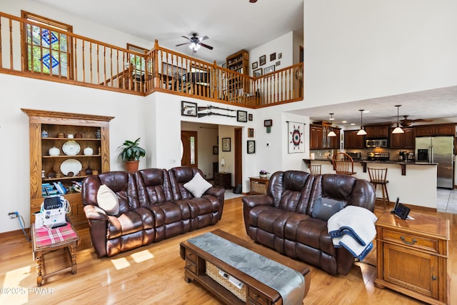 119 Canoebrook Dr, Hawley, PA 18428 - living room featuring ceiling fan, light wood-style flooring, and a high ceiling