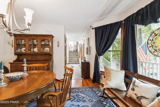 119 Canoebrook Dr, Hawley, PA 18428 - dining room featuring a chandelier, light wood-style flooring, and stairs