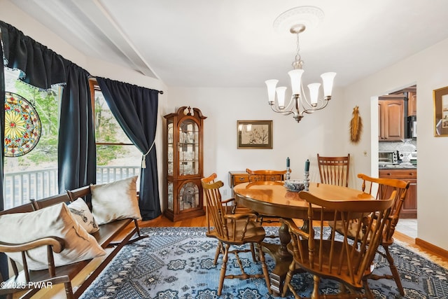 119 Canoebrook Dr, Hawley, PA 18428 - dining area with a chandelier, light wood-style flooring, and beamed ceiling