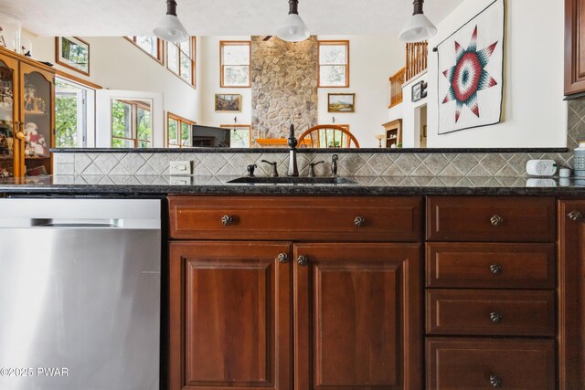 119 Canoebrook Dr, Hawley, PA 18428 - kitchen with stainless steel dishwasher, a sink, backsplash, and dark stone countertops