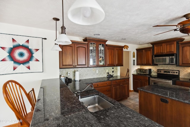 119 Canoebrook Dr, Hawley, PA 18428 - kitchen featuring appliances with stainless steel finishes, a sink, ceiling fan, decorative backsplash, and recessed lighting