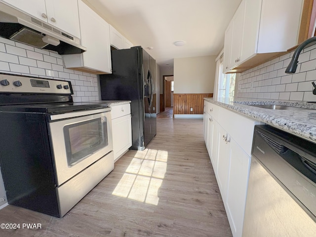 kitchen featuring white cabinets, light stone counters, sink, electric stove, and dishwasher