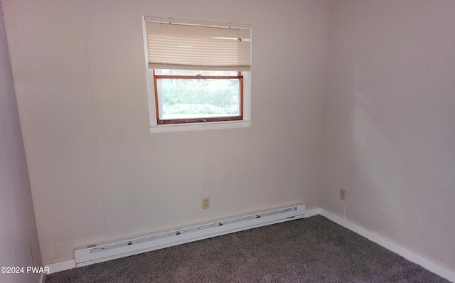 unfurnished room featuring carpet and a baseboard heating unit