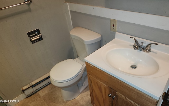 bathroom featuring tile patterned flooring, vanity, toilet, and baseboard heating