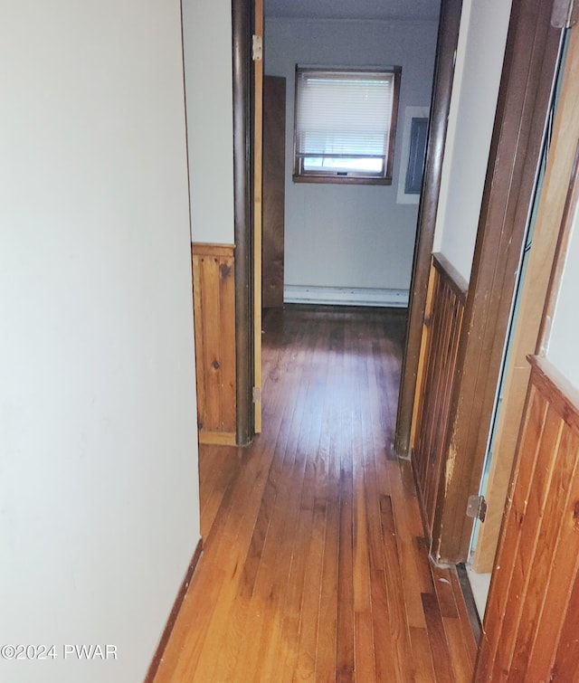 hall featuring wood-type flooring and a baseboard radiator