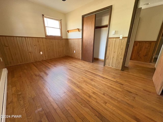 unfurnished bedroom featuring a closet and light wood-type flooring