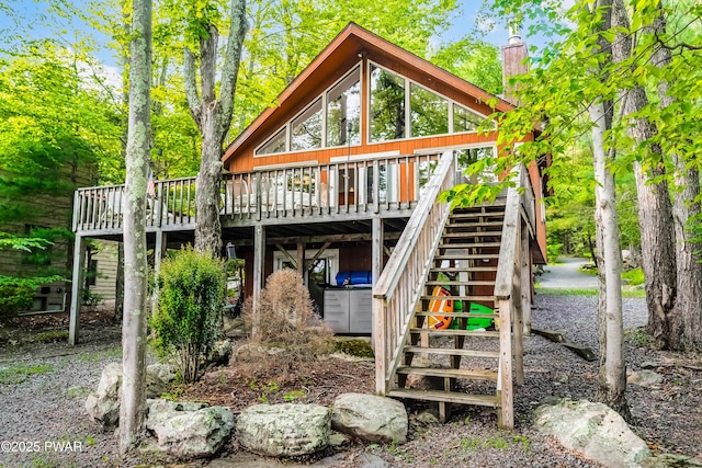 1749 Rockpoint Ct, Lake Ariel, PA 18436 - rear view of house with a deck, stairs, and a chimney
