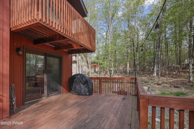 wooden terrace featuring a grill