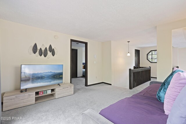 living area featuring carpet flooring and a textured ceiling