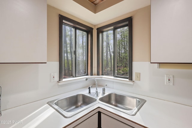 kitchen with a sink and light countertops