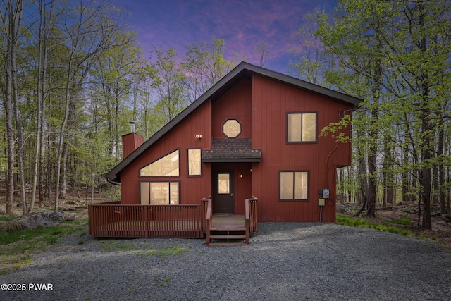chalet / cabin with a wooden deck and a chimney