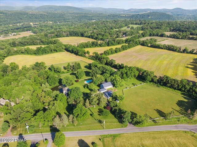 birds eye view of property with a mountain view and a rural view