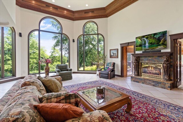 tiled living room with a towering ceiling and a premium fireplace