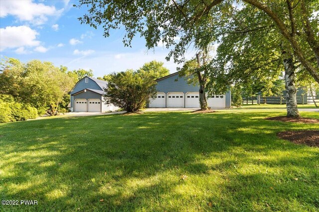 view of front of property with a garage and a front lawn