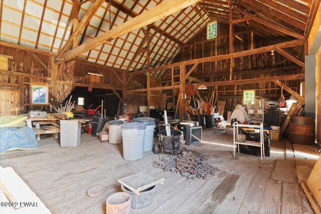 misc room featuring plenty of natural light, high vaulted ceiling, and wood-type flooring