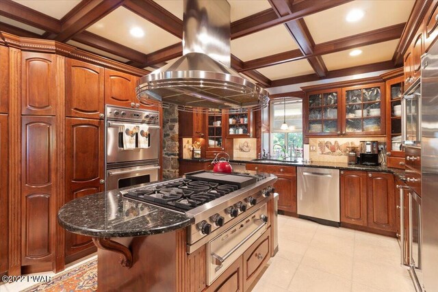 kitchen featuring a center island, coffered ceiling, dark stone countertops, appliances with stainless steel finishes, and island exhaust hood