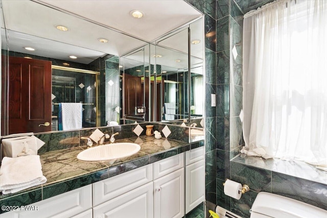 bathroom with vanity, tile walls, and walk in shower