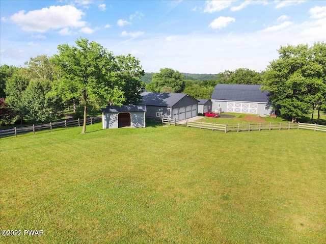 view of yard with an outbuilding and a rural view