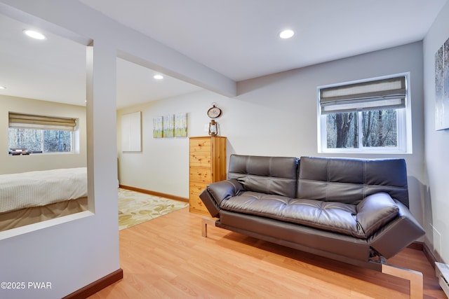 living area featuring recessed lighting, light wood-type flooring, and a baseboard radiator