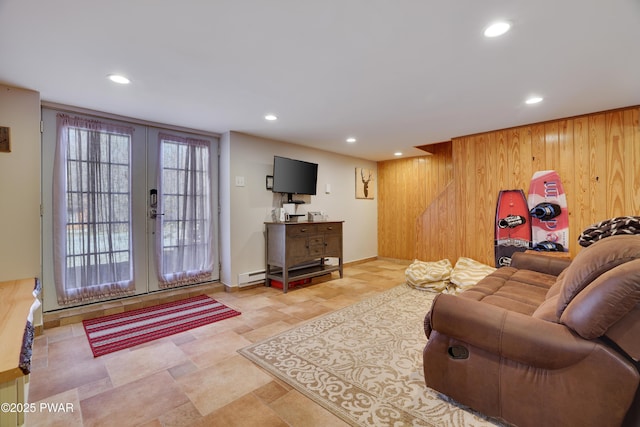 living area featuring recessed lighting, wood walls, and french doors