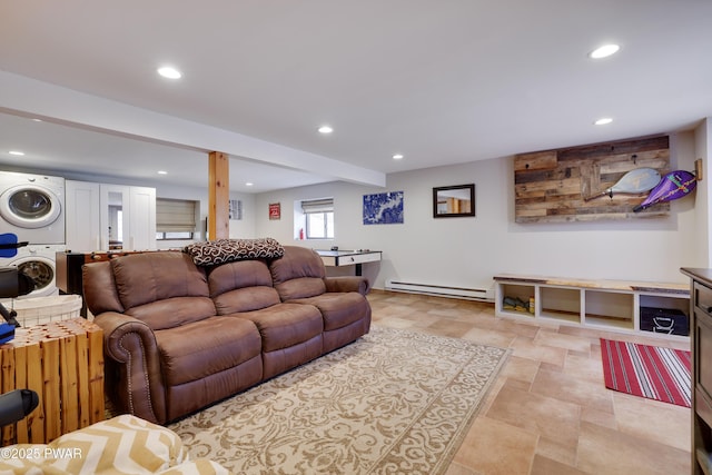 living room featuring beam ceiling, stacked washing maching and dryer, stone finish floor, recessed lighting, and a baseboard heating unit