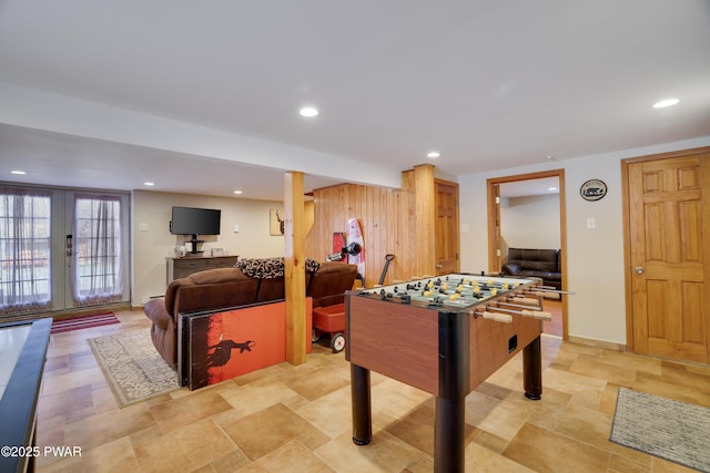 game room with french doors, recessed lighting, and stone finish flooring
