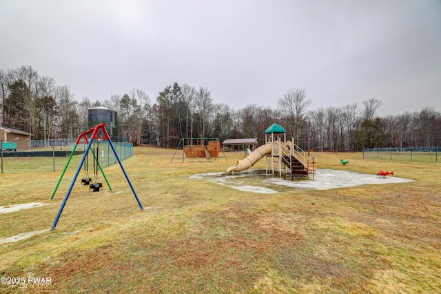 community playground featuring fence and a yard